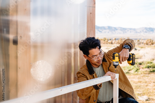 man drilling a frame photo