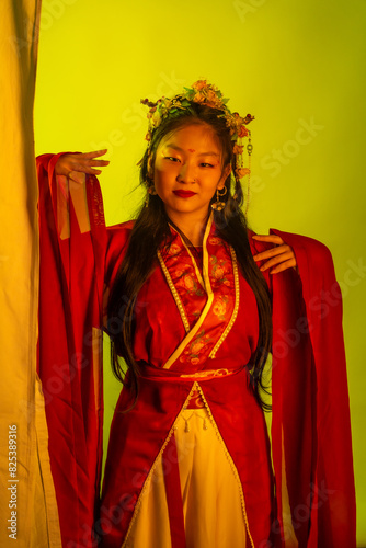 A woman in a red and white dress with a flower headpiece