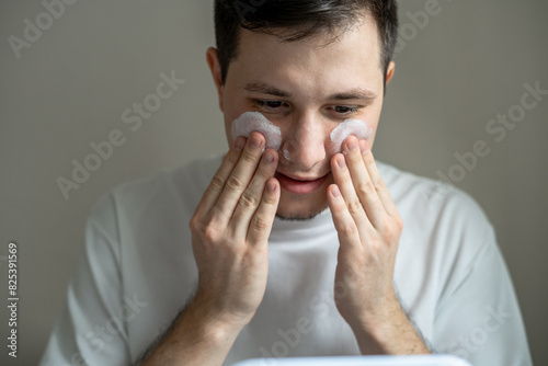 Man applying cream on his face  photo