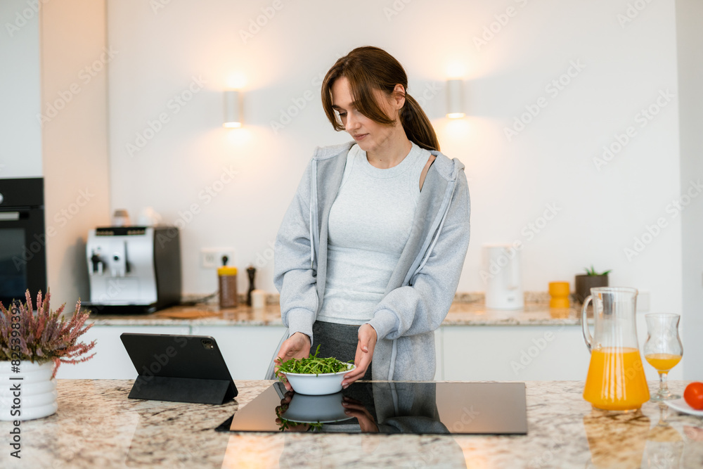 A woman uses a tablet at home A woman uses a tablet at home