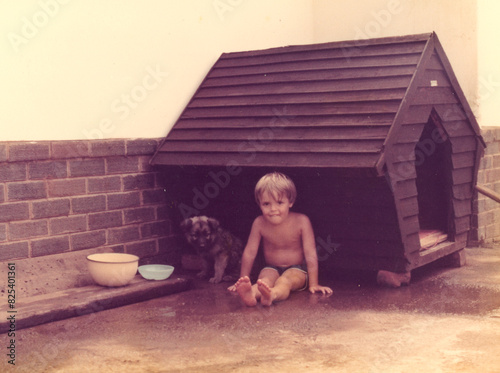 Young boy and his puppy photo