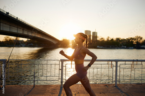 Sportswoman running beneath the bridge photo