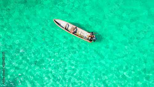Single boat drifting near the shore of Bateria beach, Sao Tome, South Africa © Wirestock
