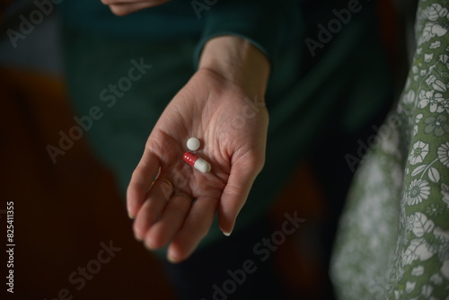 Close-Up of Hand Holding Medication Pills photo