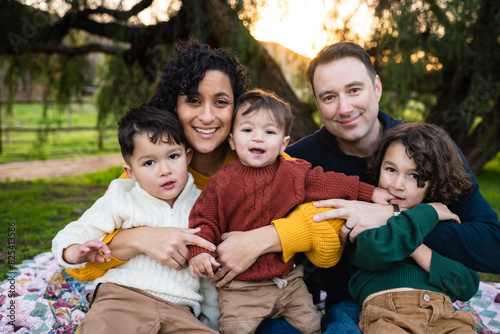 Lifestyle Family Portrait of Young Family Smiling Together at Sunset