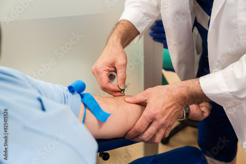 Healthcare professional drawing blood from patient photo