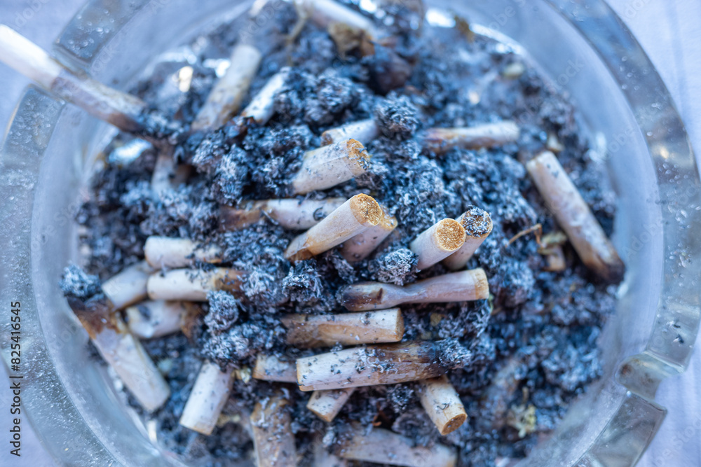ashtray full of cigarette butts from rolling tobacco cigars ashtray full of cigarette butts from rolling tobacco cigars