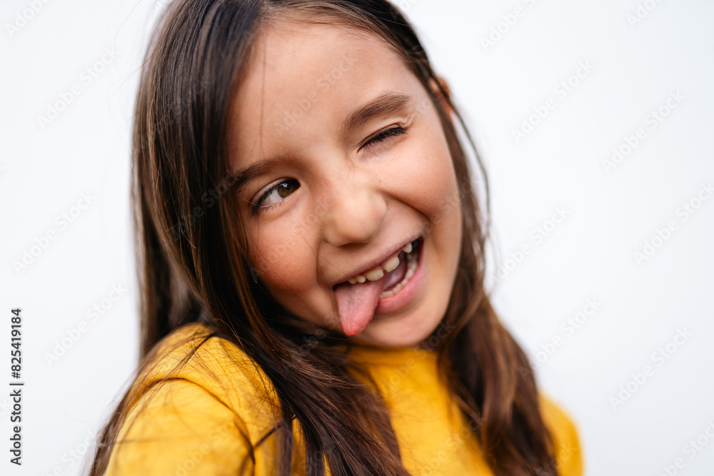 Happy Young tween Girl Playfully Sticking Out Tongue Stock Photo