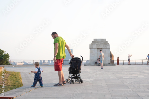 Father walks his son along the promenade photo