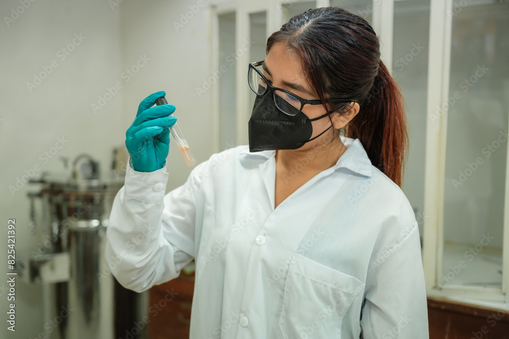 Female scientist analyzing sample in test tube Female scientist analyzing sample in test tube