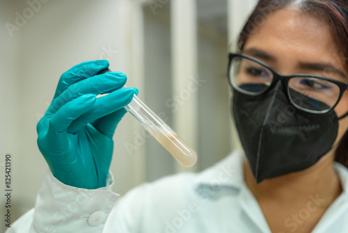 Female scientist holding test tube photo