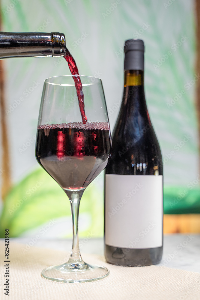 the wine is pouring into the glass to be poured into the wine is pouring into the glass to be poured into