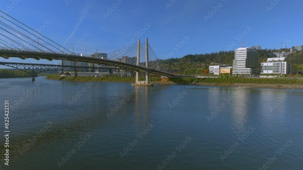 Aerial, Flying Backwards, Close to the water, View of Tilikum Crossing Bridge at Sunrise Aerial, Flying Backwards, Close to the water, View of Tilikum Crossing Bridge at Sunrise