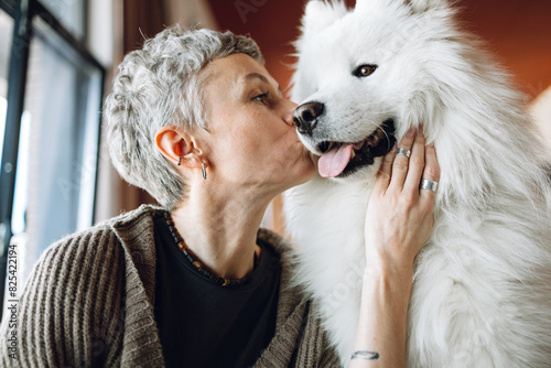 A woman with a dog at home photo