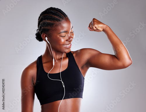 Studio, black woman and flex with smile for fitness, bicep and strong muscle by mockup space. Female model, arm strength and bodybuilder in gray background for training, exercise and results for goal