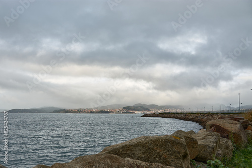 Breakwater in Bouzas, Vigo, Spain under a cloudy sky photo