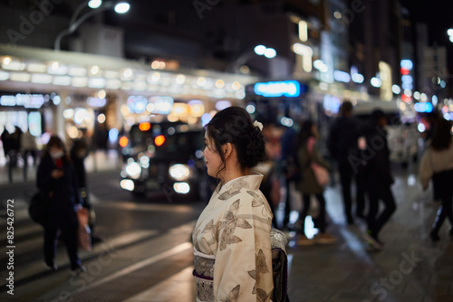 Asian Woman Wearing A Kimono At Night In Kyoto, Japan. photo