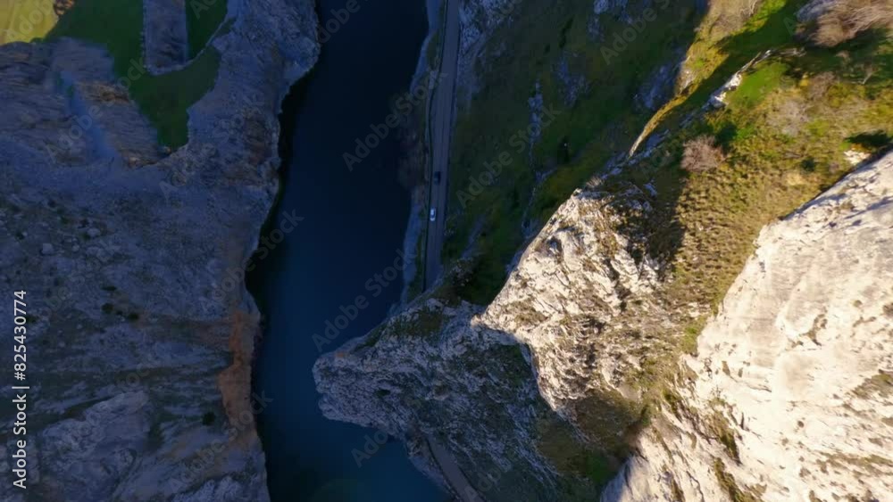 Drone view revealing mountains landscape with a lake and road on a sunny day with blue sky Drone view revealing mountains landscape with a lake and road on a sunny day with blue sky