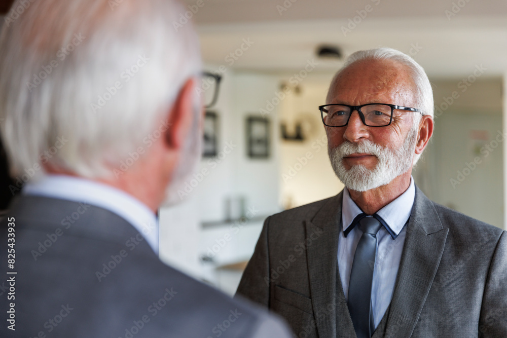 Confident senior businessman in front of mirror Confident senior businessman in front of mirror
