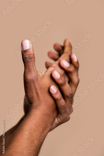 Clasped hands on neutral background