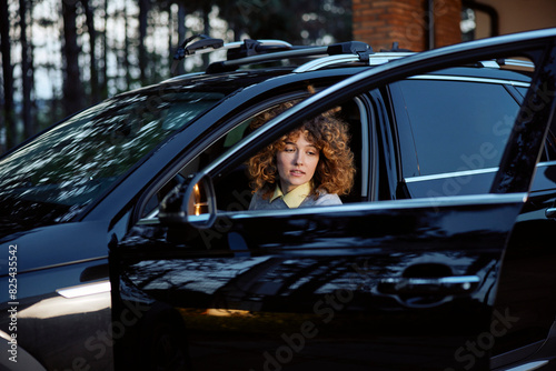 Portrait of a woman sits in the black car photo