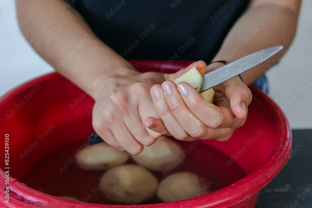 Woman cutting potatoes Woman cutting potatoes