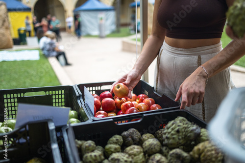 Buying fruits and vegetables at an outdoor market photo