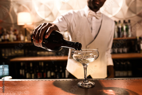 Bartender pouring champagne into the glass  photo