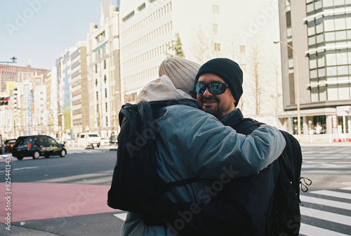 Two friend hugs in the street in Tokyo photo