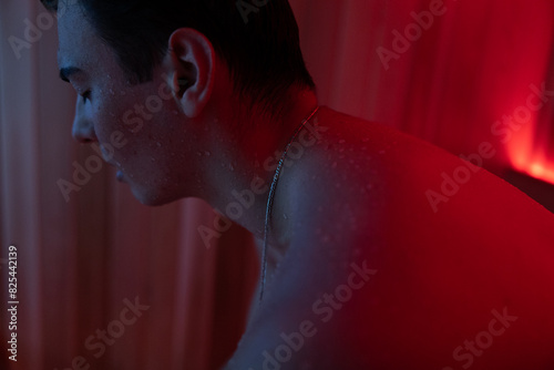 Profile view of neck in red light photo