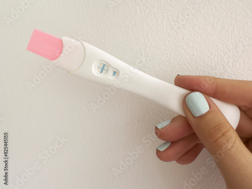 Positive pregnancy test in hand closeup