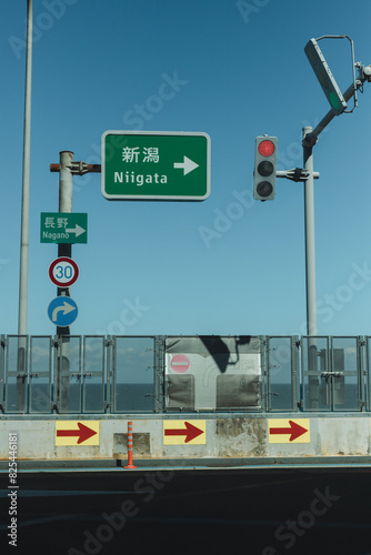 Japanese street sign at an intersection 