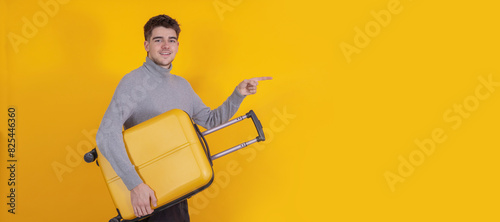 isolated young man or student with suitcase pointing