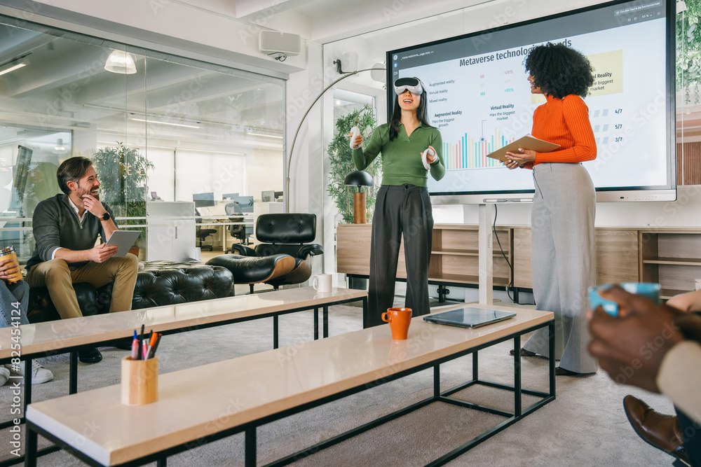 © VICTOR TORRES/Stocksy - Team discussing metaverse trends in a tech presentation © VICTOR TORRES/Stocksy - Team discussing metaverse trends in a tech presentation