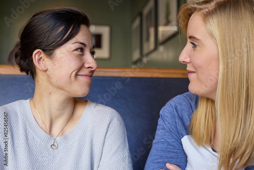Lesbian couple in conversation at cafe photo