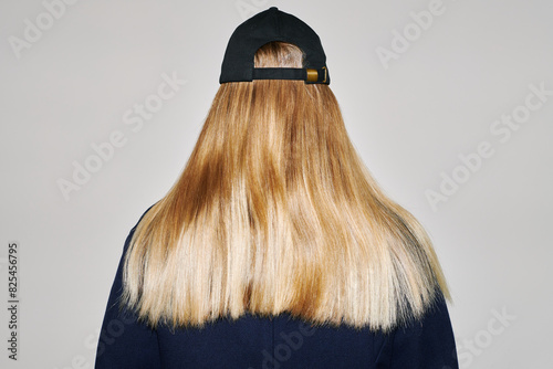 Woman with long blond hair wearing a cap photo