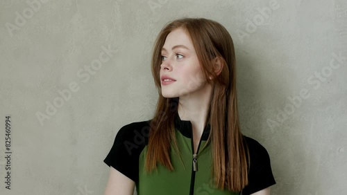 young girl in a tracksuit on a wall background. Free space for text. Wide angle horizontal wallpaper or web banner. 
