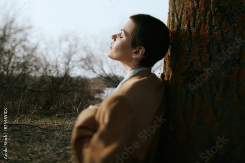 Woman Leaning On Tree photo