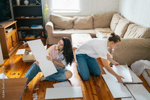Women assembling furniture at home photo