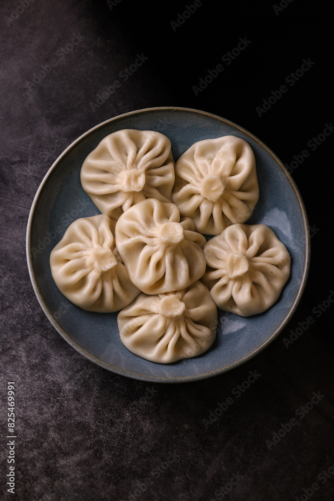 Traditional Khinkali Dumplings on Dark Slate Traditional Khinkali Dumplings on Dark Slate
