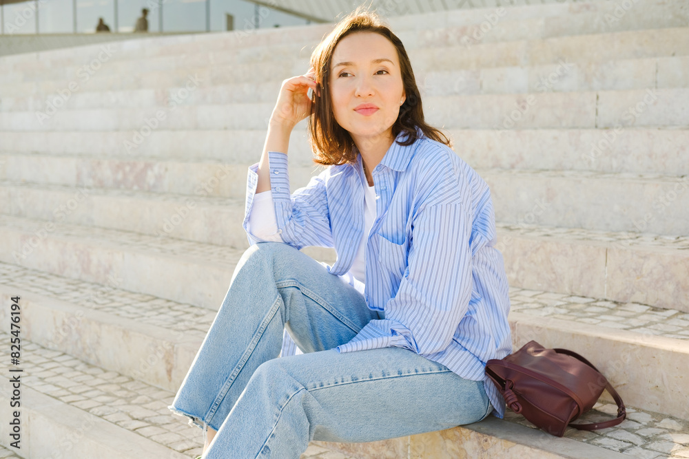 Woman sitting on the stairs looking aside Woman sitting on the stairs looking aside