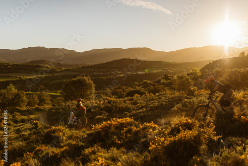Mountain bikers at sunrise photo
