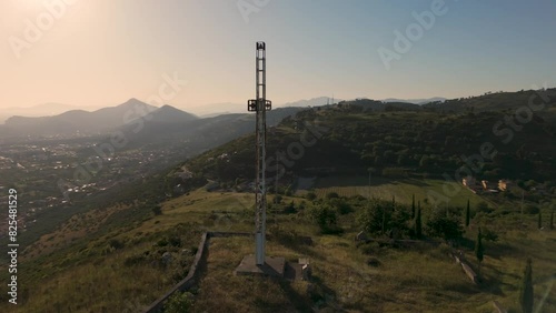 Aerial view of a Catholic cross on top of the mountain in Casola, Caserta, Italy photo