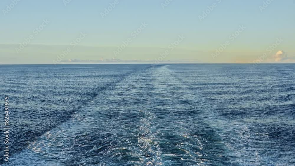 A tranquil scene showing the wake of a ship traveling on the Norwegian Sea during a serene morning A tranquil scene showing the wake of a ship traveling on the Norwegian Sea during a serene morning