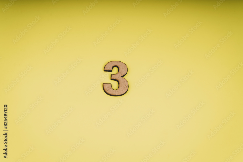 Number three in leather on yellow background 