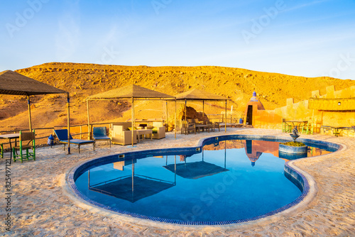 Swimming pool in traditional riad kasbah guesthouse at sunrise in Ait Ben Haddou village, Morocco, North Africa photo