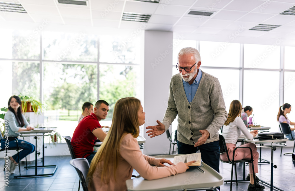 Obraz premium Students listening to an older high school teacher.