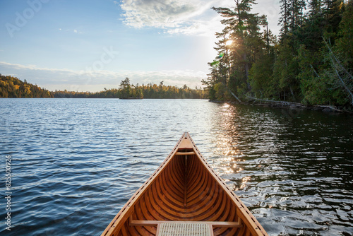 Wooden canoe on a blue Boundary Waters lake at dawn on an autumn morning photo