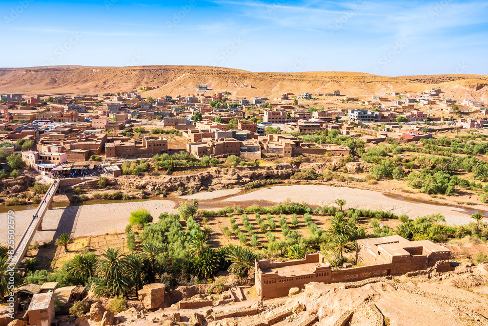 View of Ait Ben Haddou, old Berber ancient village or kasbah with river and green oasis with palm trees, Ouarzazate, Morocco, North Africa