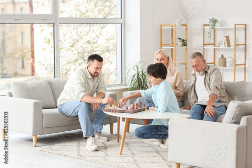 Little boy playing chess wi...